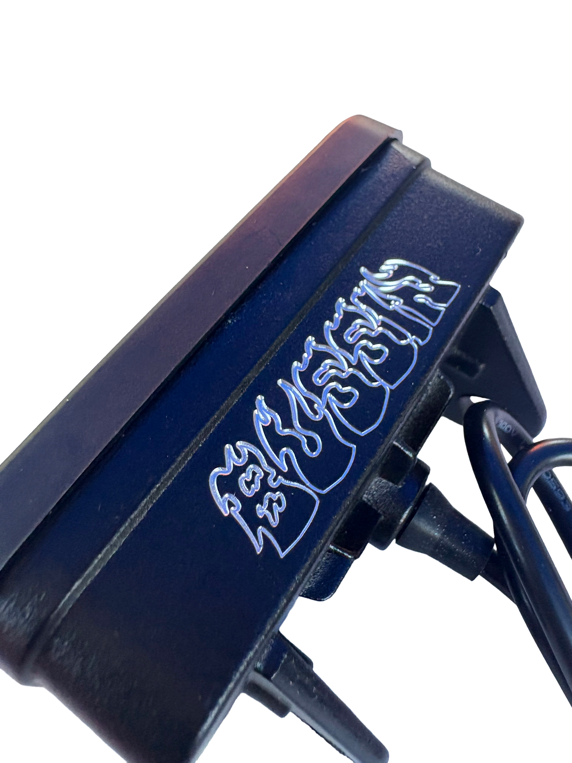 Close-up of a black electronic device with stylized silver lettering, shown against a plain white background.