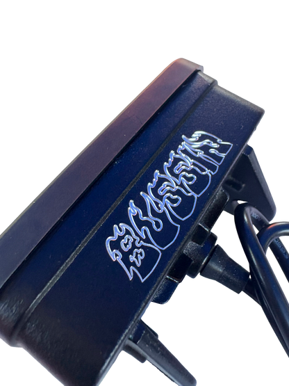 Close-up of a black electronic device with stylized silver lettering, shown against a plain white background.