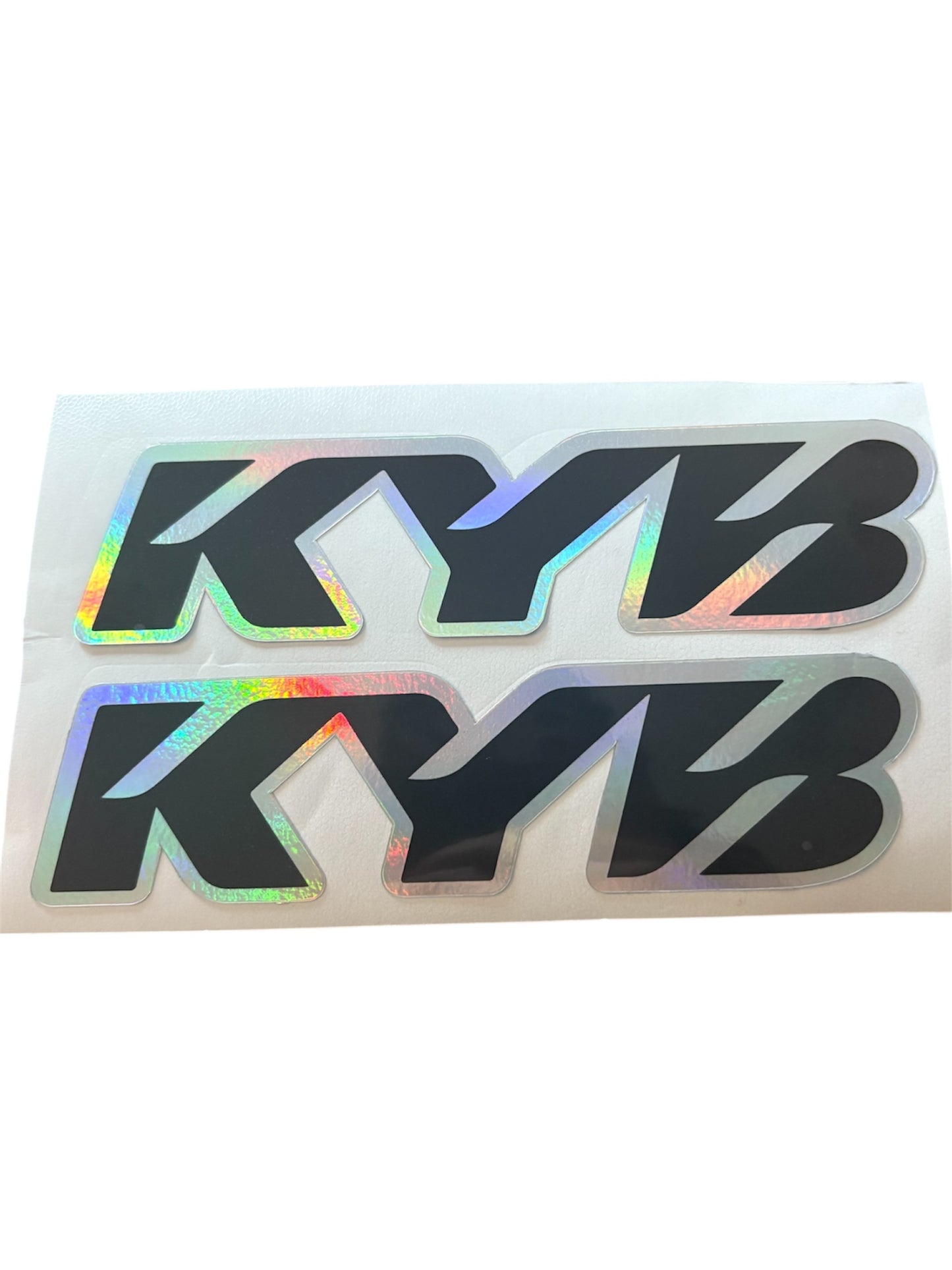 Holographic KYB logo decal on a white background