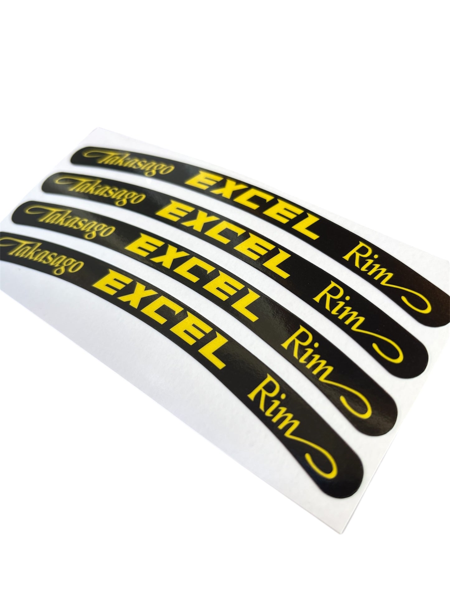 Set of five black and yellow rim decals with 'Takasago Excel Rim' text on a white background