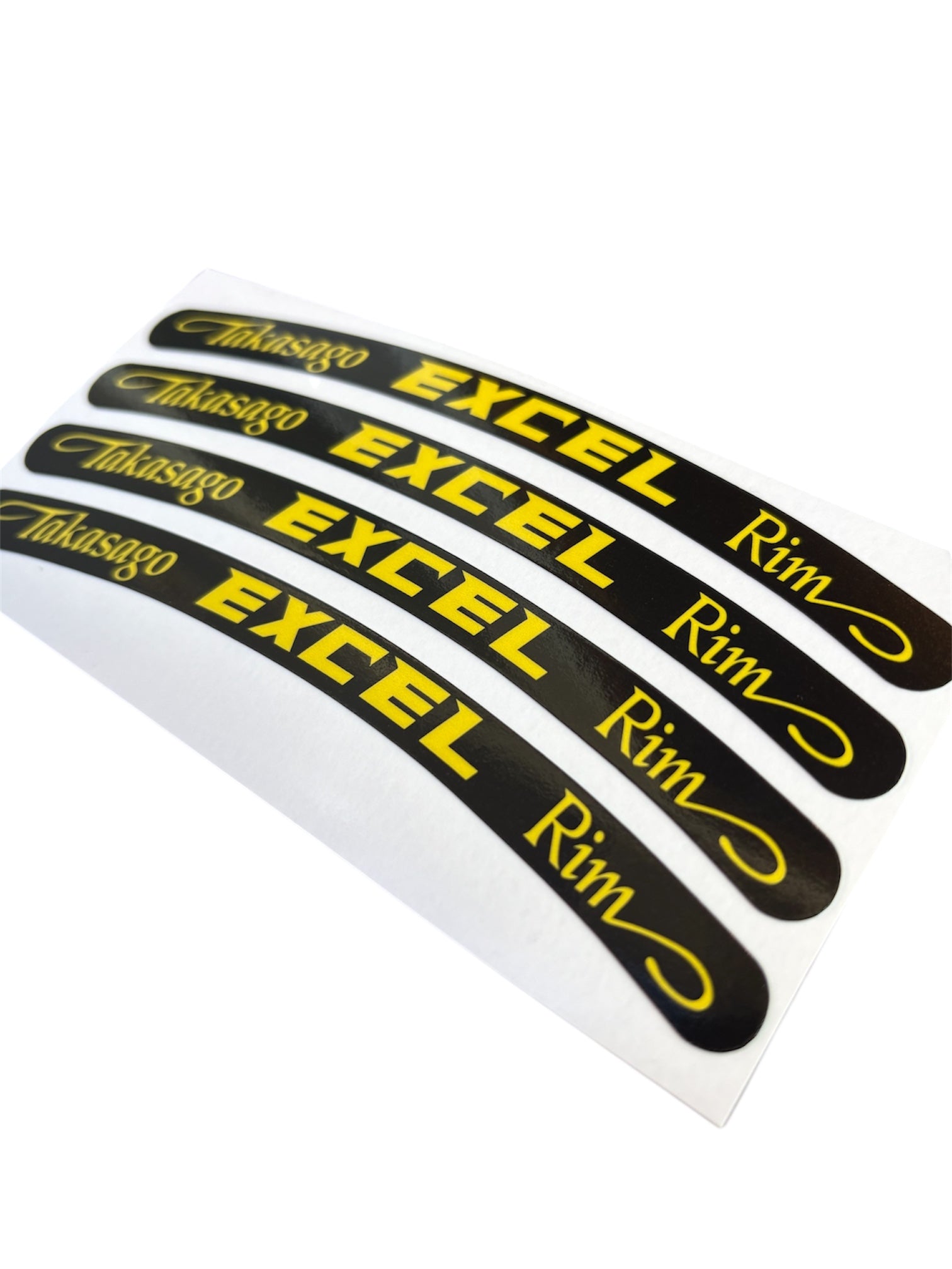 Set of five black and yellow rim decals with 'Takasago Excel Rim' text on a white background