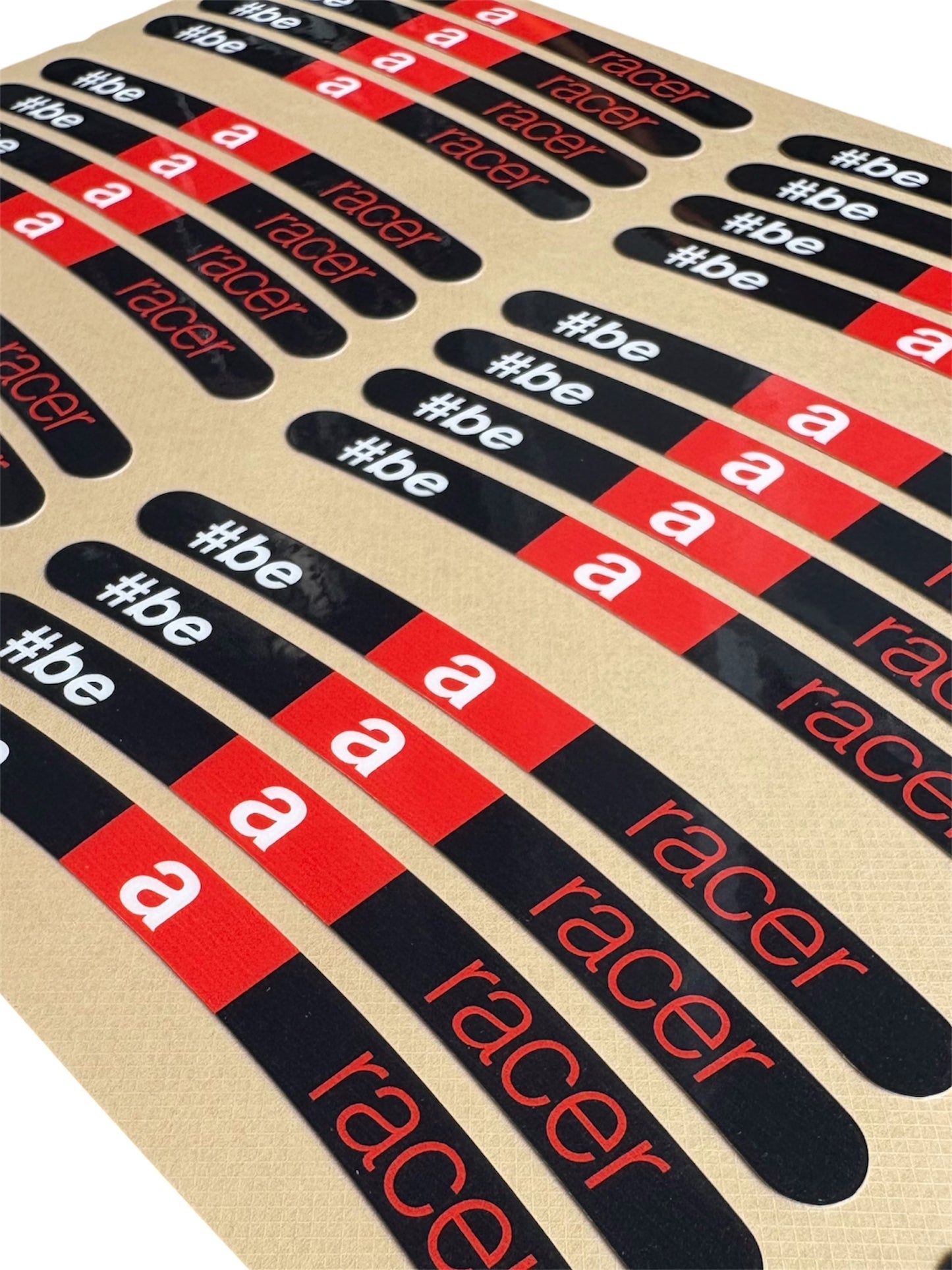 Set of 'be a racer' stickers in red, black, and white on a beige background